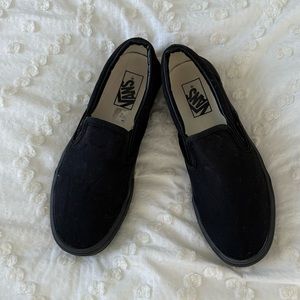 All black Vans slip ons